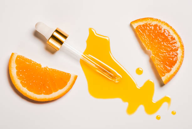 Oil serum vitamin C pipette and drops on white background copy space skin care beauty product. Anti aging antioxidant beauty serum vitamin C oil natural cosmetic.