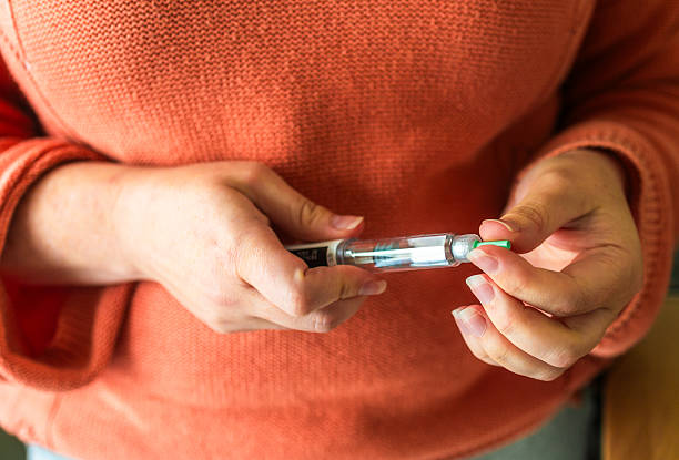 Close up of a woman's hands holding a weight loss injection syringe. Semaglutide and Tirzepatide