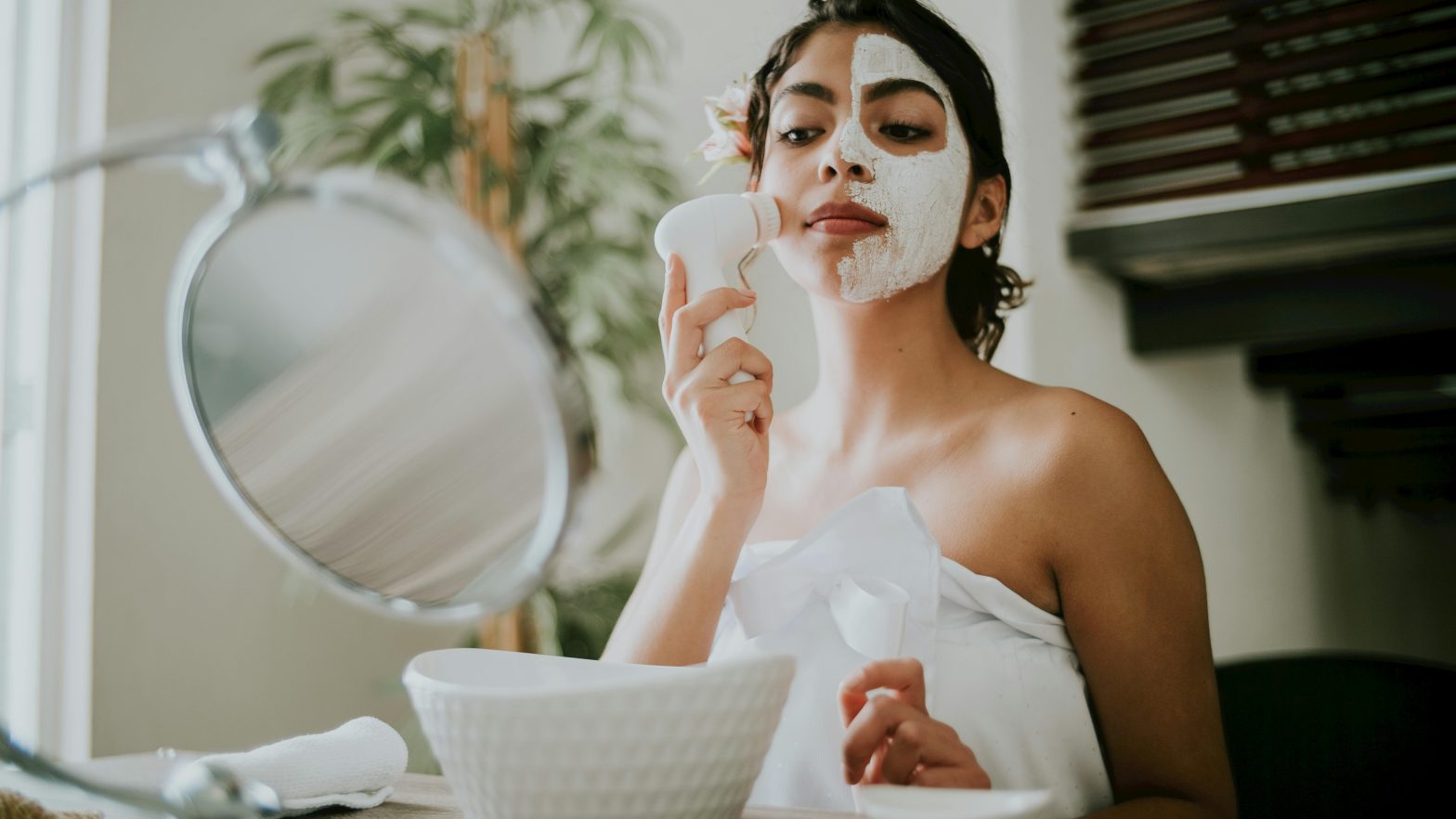 Skincare layering. Woman in White Tube Top Holding White Facial Cleanser